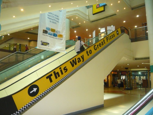 Wayfinding and Typographic Signs - escalator-to-great-pizza
