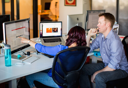 Two people collaborating on a web design