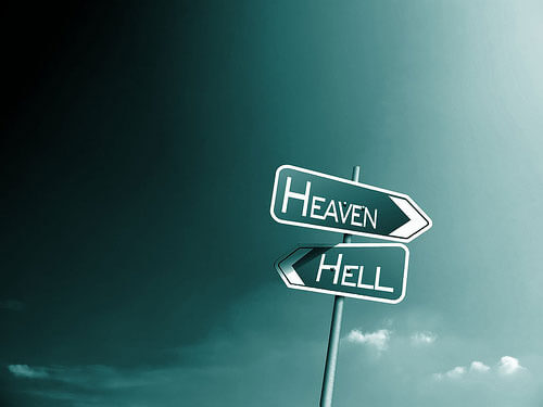 Photo of a road sign containing heaven and hell