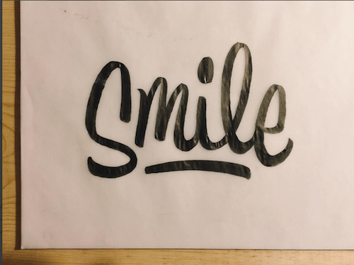 Smile, hand lettering by Sean Tulgetske
