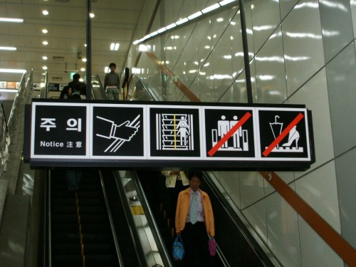 Wayfinding and Typographic Signs - notice-on-escalator