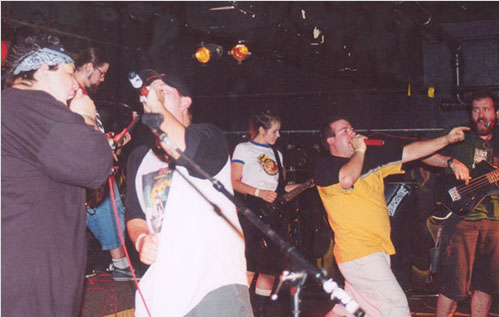 The band and friends rocking out on stage in 2003 and making music as a team.