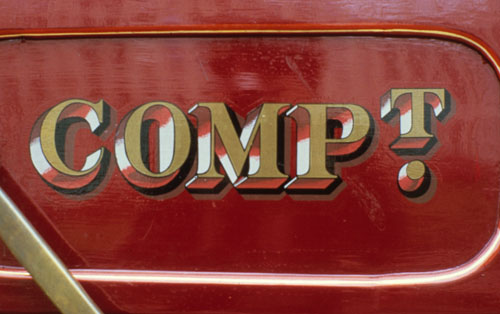 Elaborately detailed lettering in a third-class compartment.