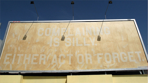 Poster reading "Complaining is silly. Either act or forget."