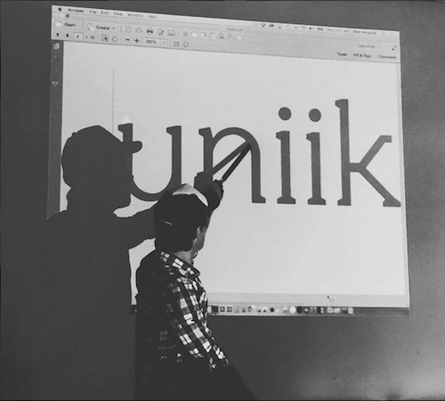 Matt Vergotis pointing the work uniikon a presentation