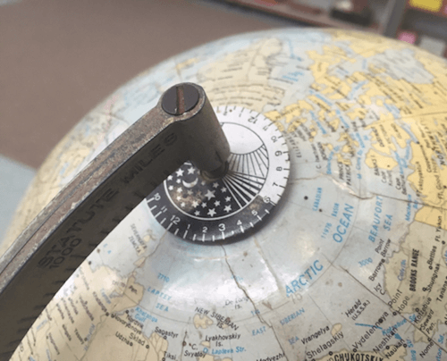 A globe with a 24-hour clock face
